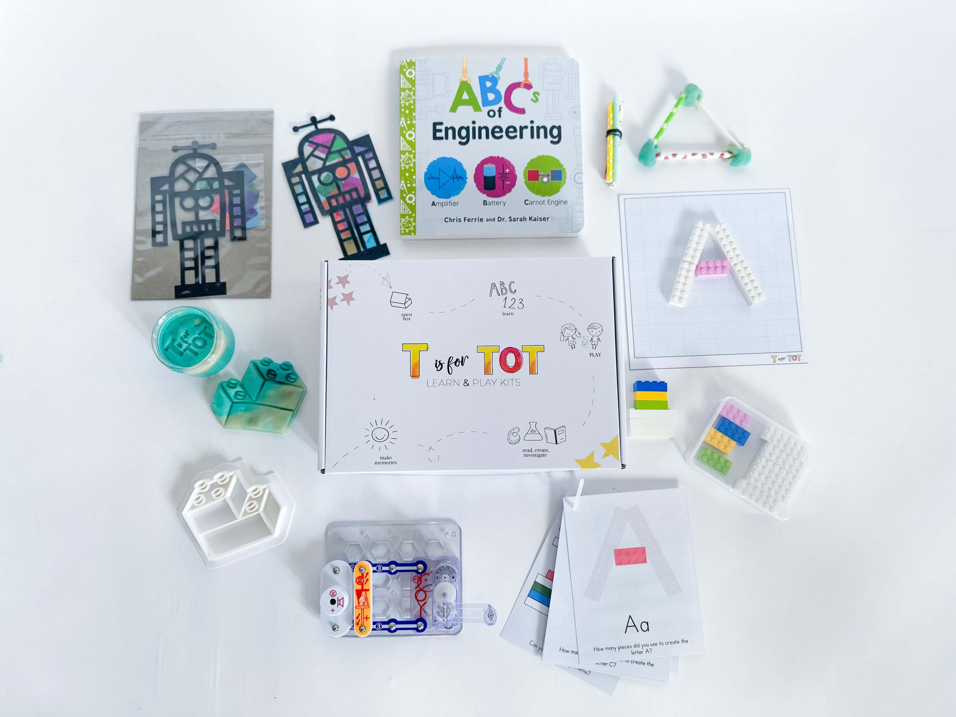 Engineering-focused play and learn kit for kids. Comes with a snap circuit for ages 3-6, Lego playdough cutter, homemade playdough, Robot Suncatcher, straw STEM activity, and educational Lego cards in a plastic case. Great for early STEM exploration.