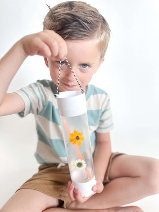 Explore nature in your own backyard with this camping kit for kids. Comes with binoculars, compass, flower press, lantern craft, homemade playdough with cutter, nature walk bag, tic-tac-toe, and camping coins for storytelling.