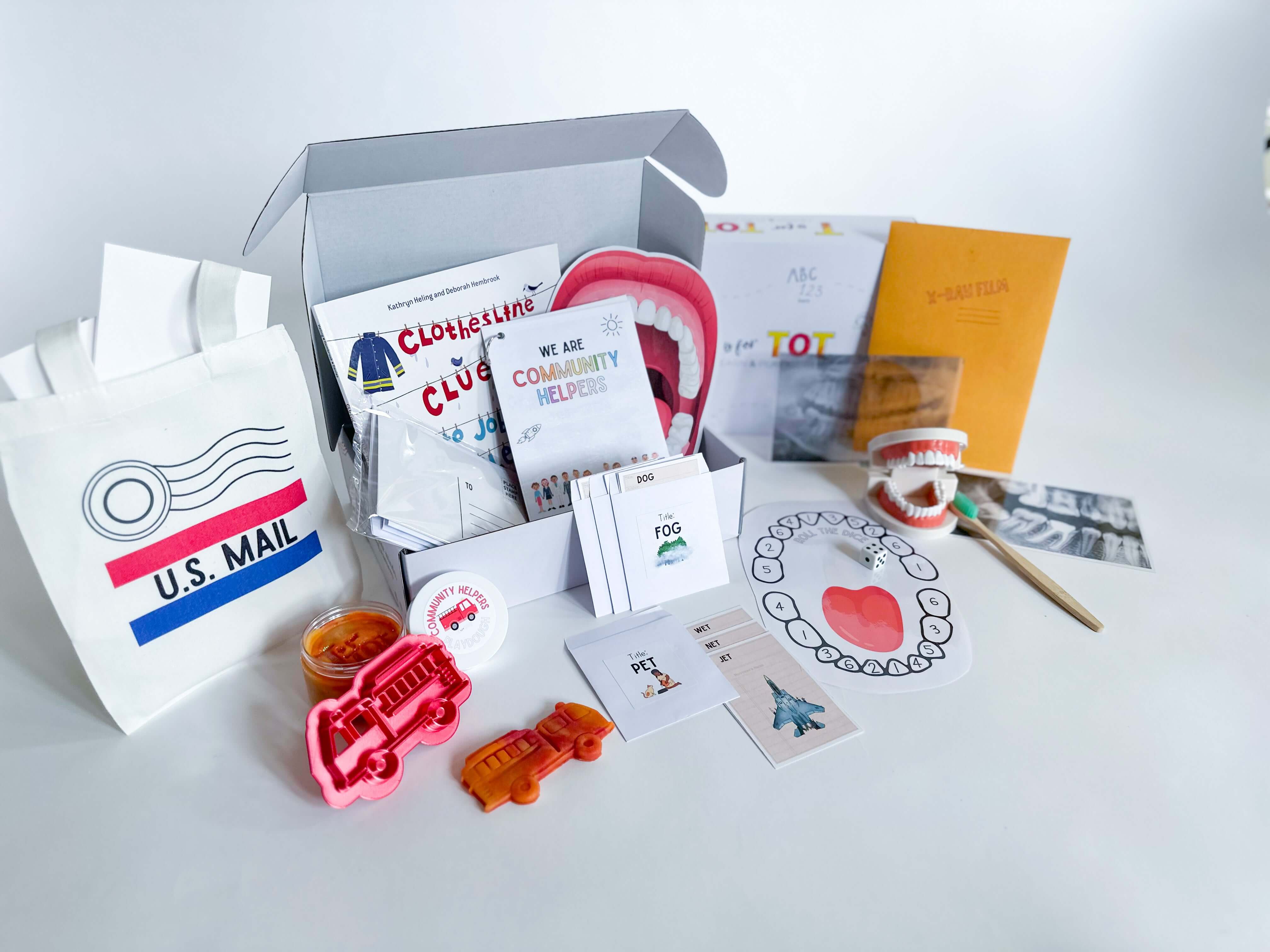 Learn about Community Helpers with this play kit for kids aged 3-6. Includes fire engine playdough cutter, homemade playdough, dental x-rays, Clothesline Clues book, library card rhyming game, and mailbag with letters for role-playing.