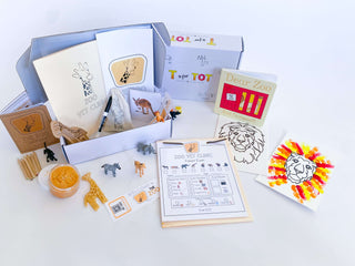 Play and learn zoo kit for kids with a giraffe playdough cutter, homemade playdough, zoo map, vet folder, and a 