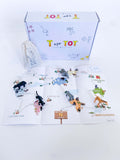 Zoo play and learn kit for kids with a giraffe playdough cutter, homemade playdough, zoo map, and vet folder for pretend play. Features a zoo sketch journal, play animals in a pouch, and a scavenger hunt for identifying zoo animals.