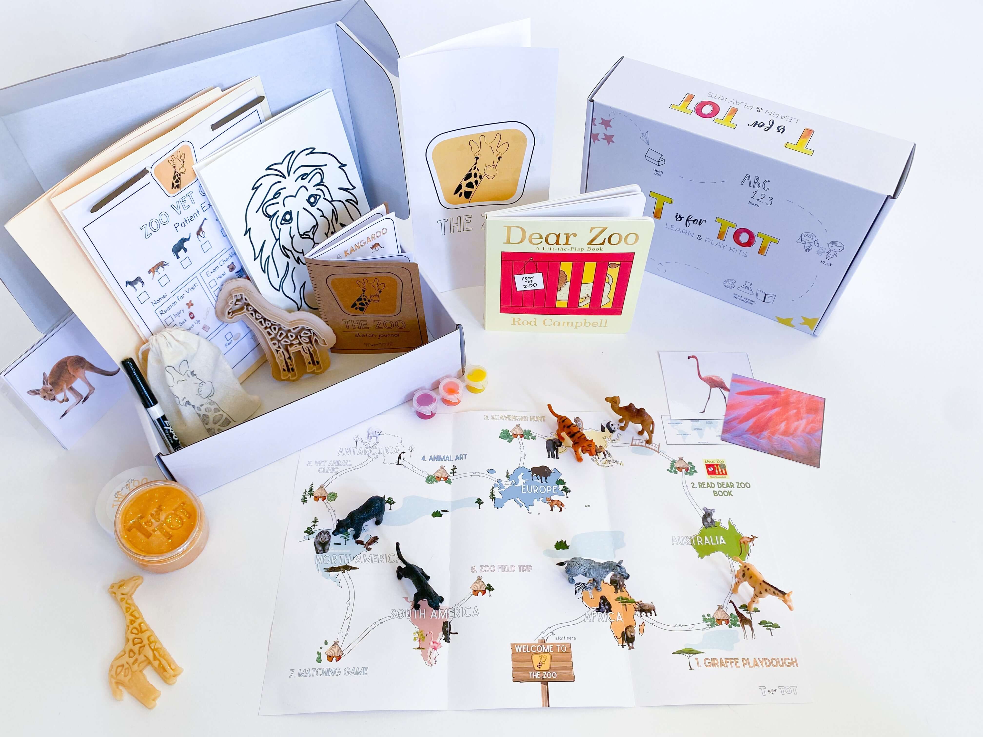Zoo-themed play and learn kit for kids with giraffe playdough cutter, homemade playdough, zoo map, vet folder with expo marker, play animals, and 